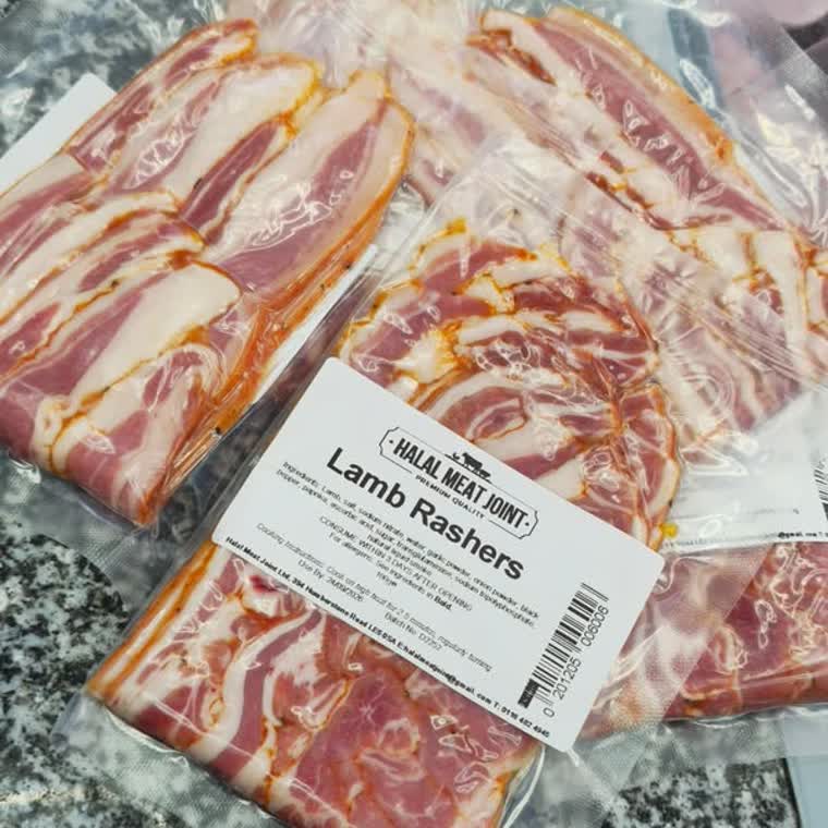 Packs of Halal Meat Joint lamb rashers on a marble counter