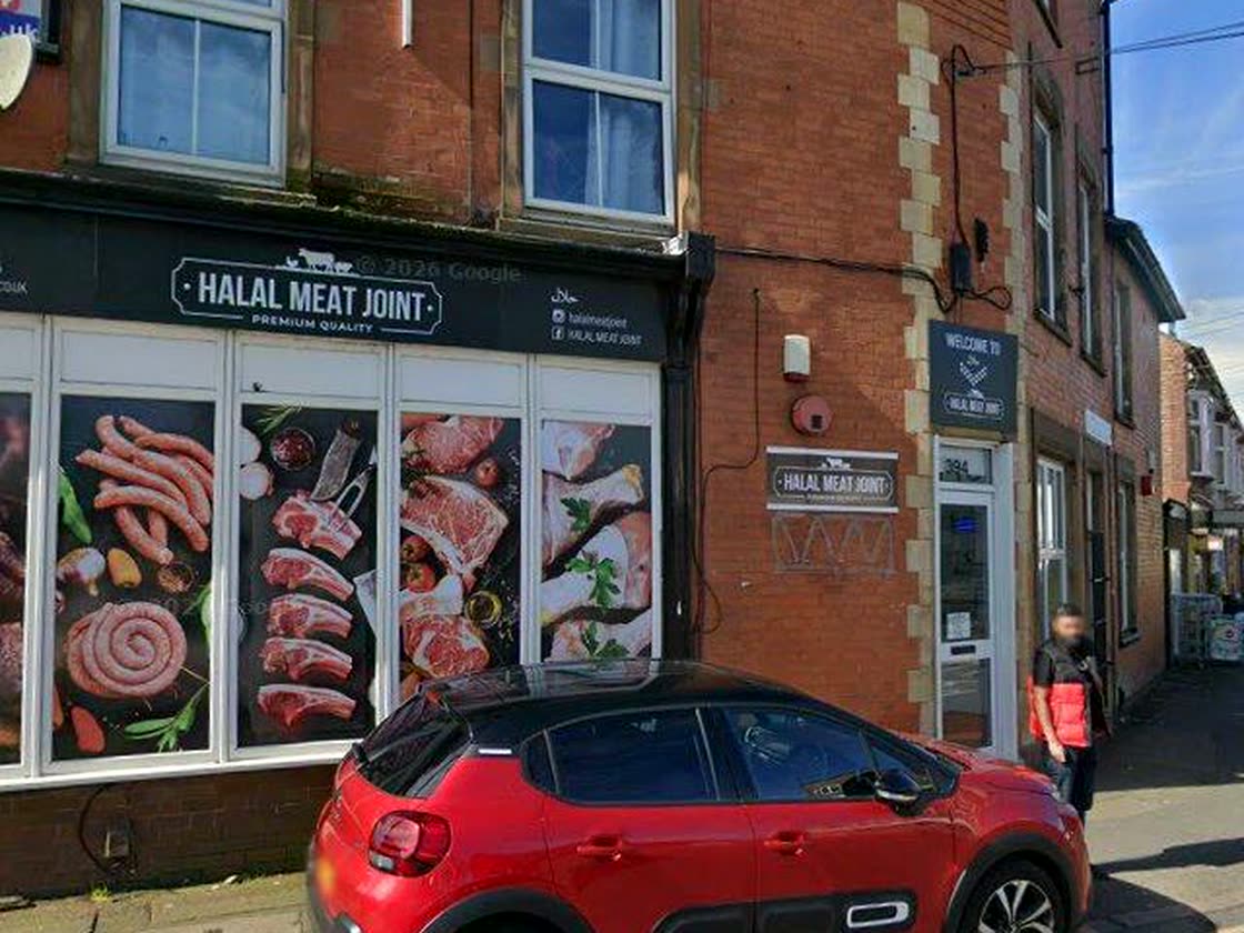 The Halal Meat Joint shopfront on Humberstone Road: a black fascia over red brick, with the shop name in white.